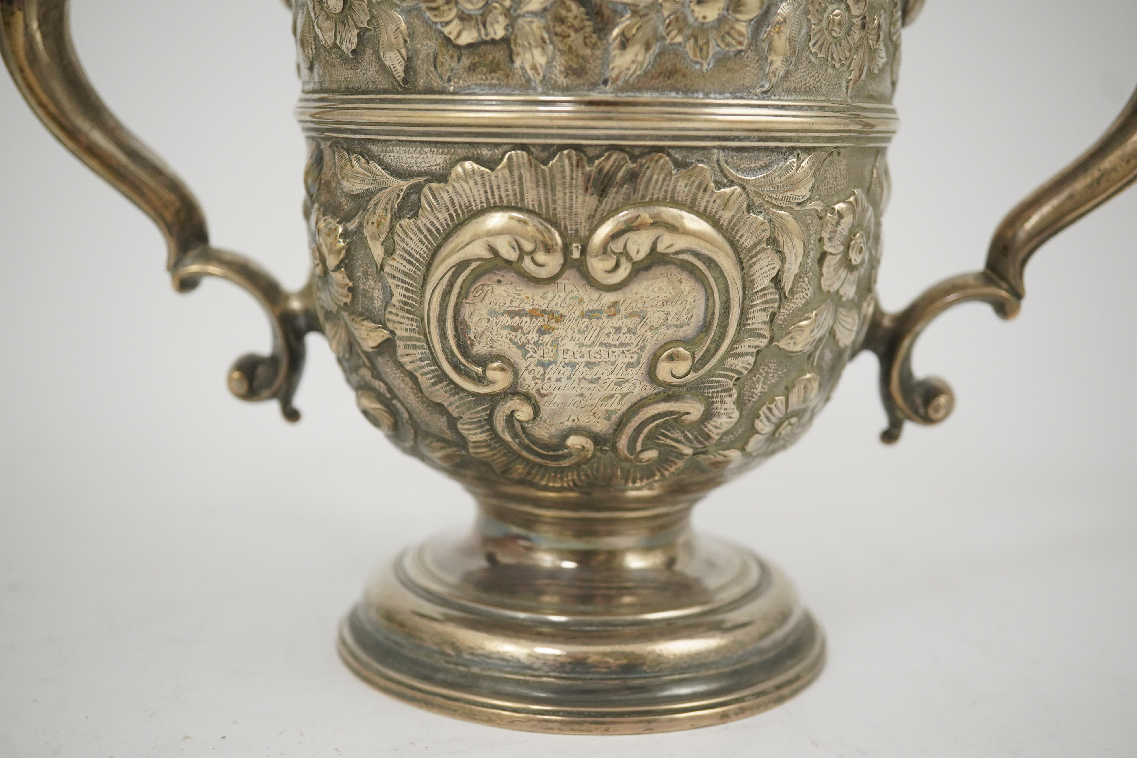 A George II silver loving cup with later floral embossed decoration, maker's initials RI, London, 1745